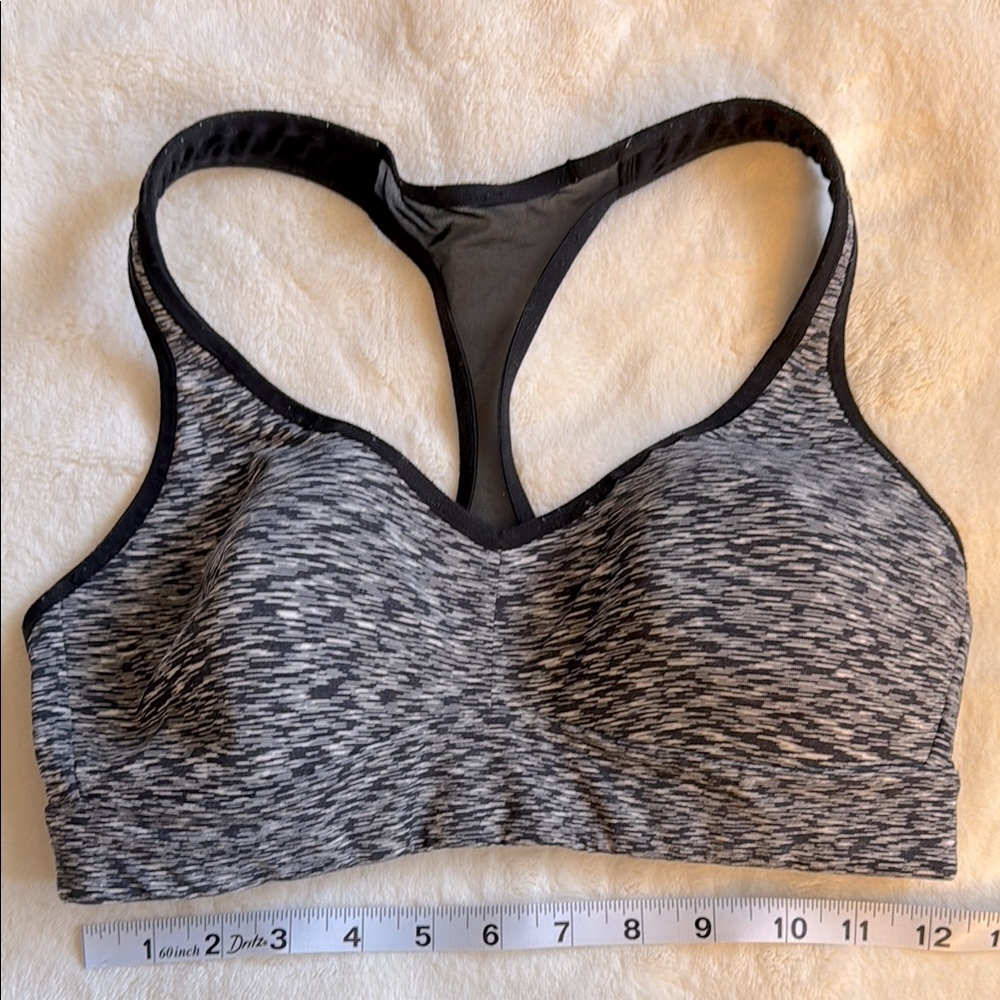 Lululemon racerback bra with marked B&W front and mesh racerback, size 6.
